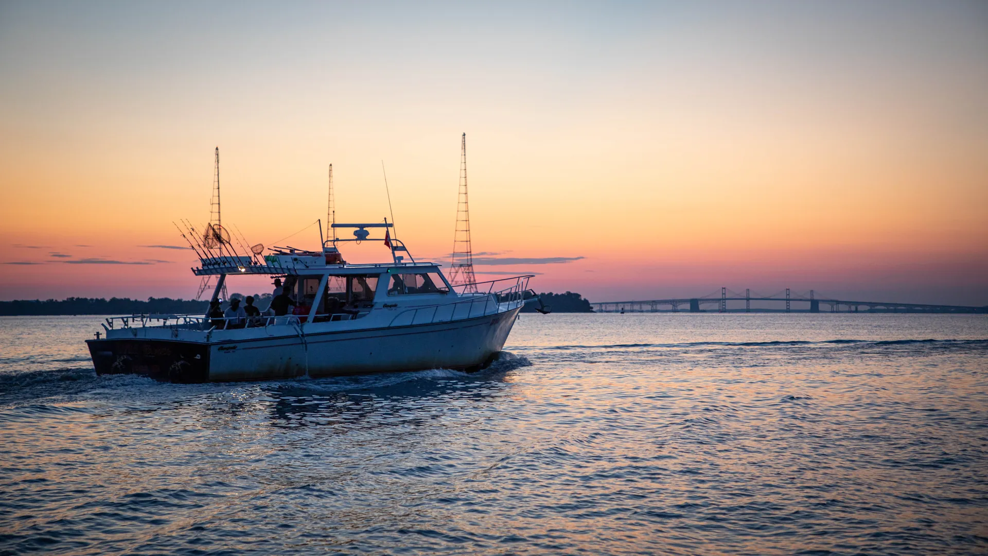 Fishing charter boat underway at sunrise